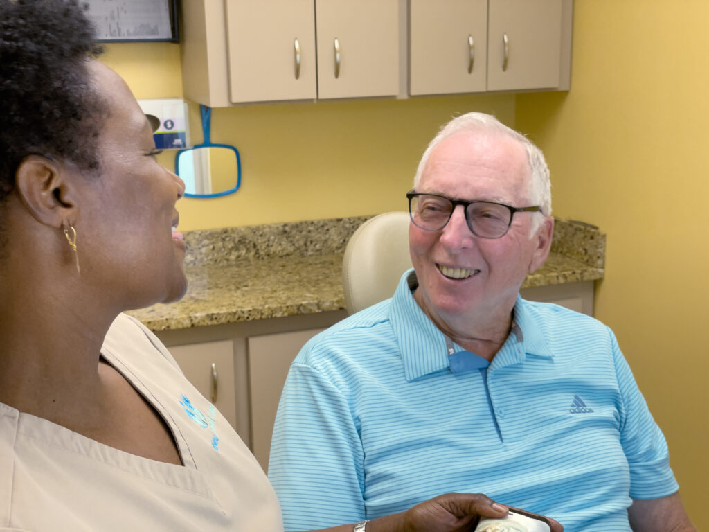 ReNew Dental team member and patient smiling chairside