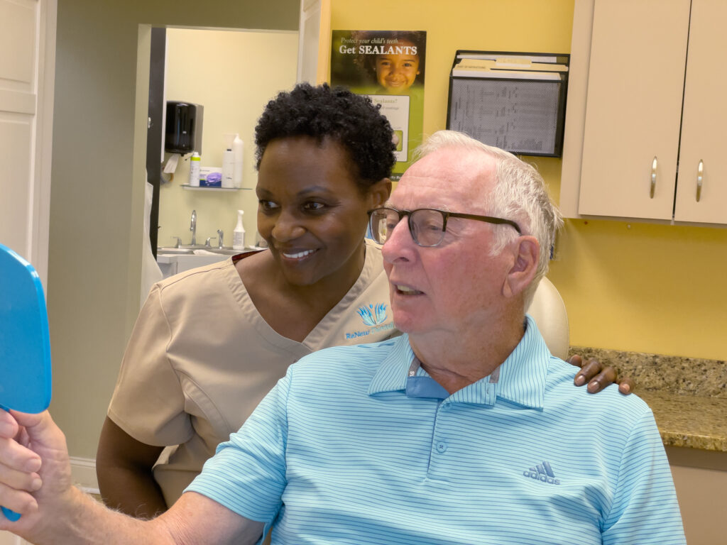 ReNew staff and patient smiling during a consultation