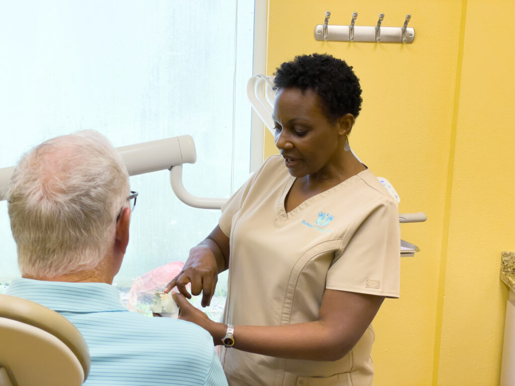 ReNew dentist consulting with a patient chairside